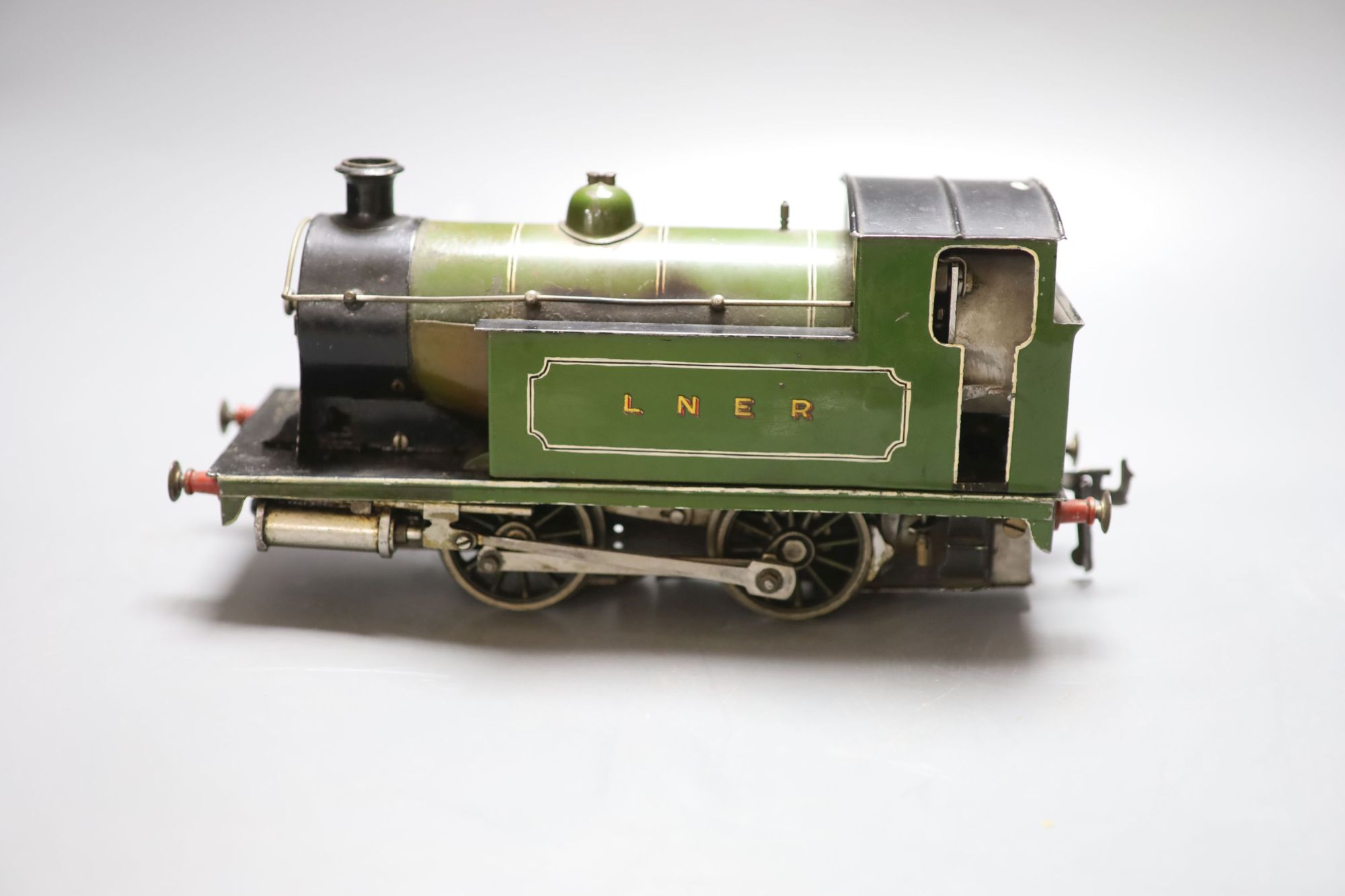 An early 20th century tinplate live steam loco converted to electricity, length 28cm